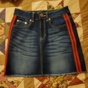 Never worn before denim skirt with a red stripe
